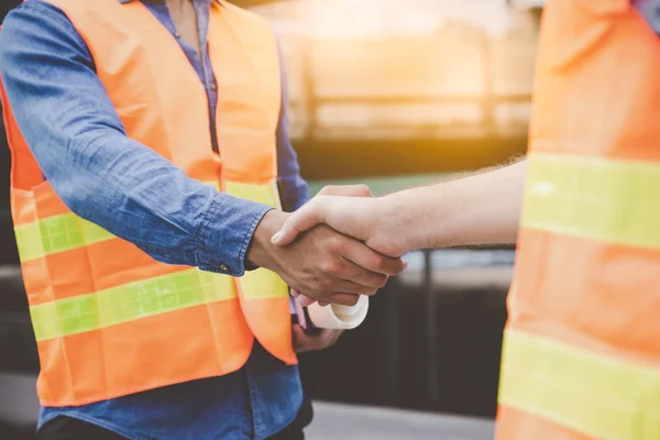 depositphotos_332248020-stock-photo-engineer-men-making-handshake-construction